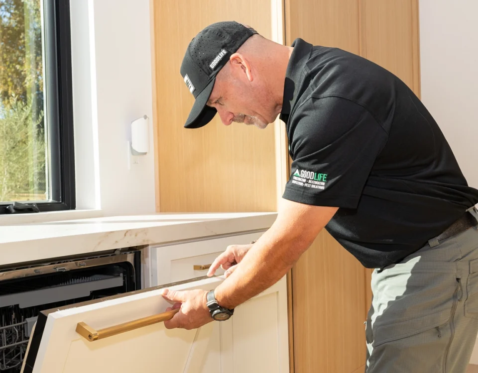 Good Life Inspections Inspector is looking at dishwasher cabinet panel