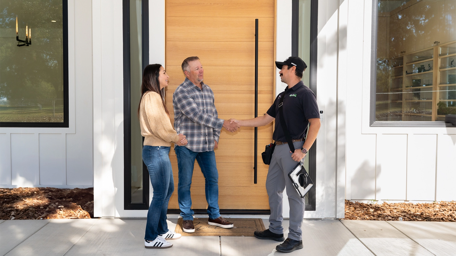 The homeowners are welcoming Good Life Inspection Home Inspector near the house